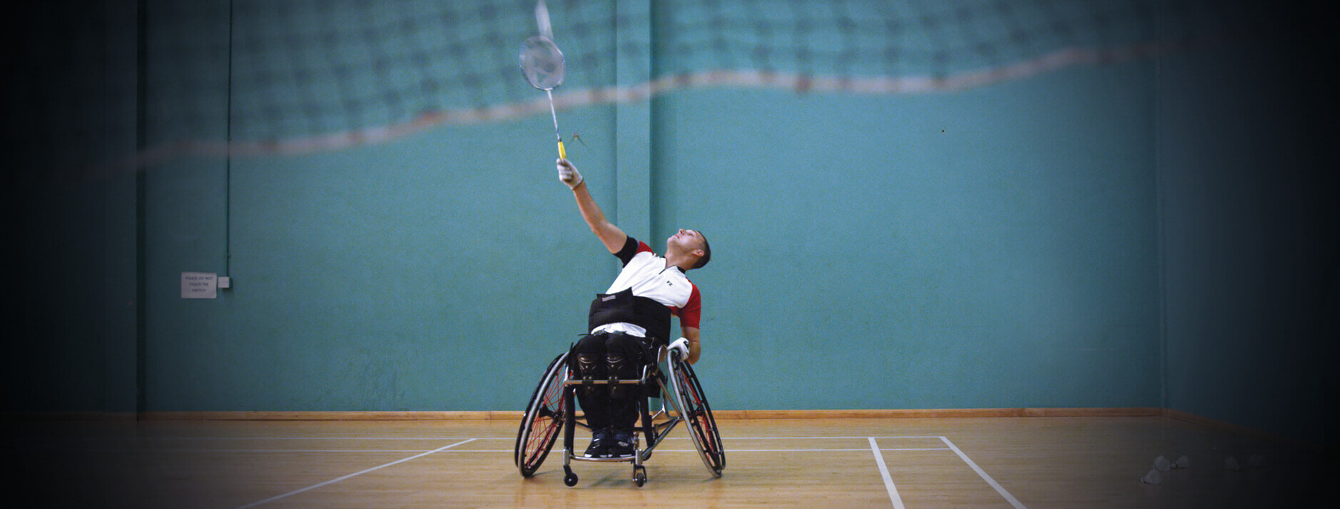 Man playing wheelchair badminton